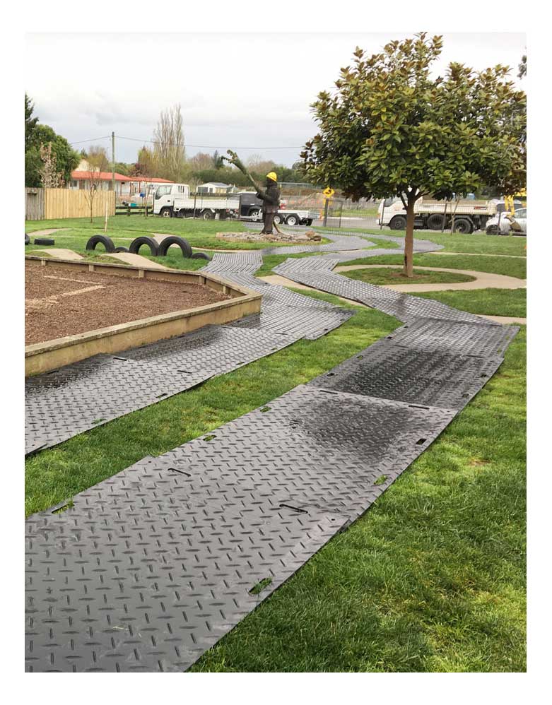 Ground protection mats laid out for a truck to drive on